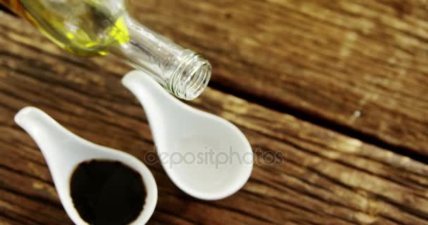 Olive oil being poured into appetizer spoon — Stock Video