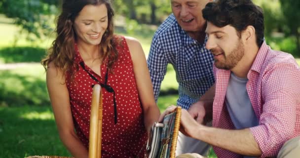 Family looking at wicker basket — Stock Video