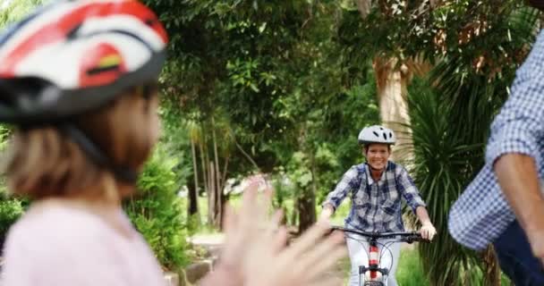 Parents riding bicycle and kids cheering them — Stock Video