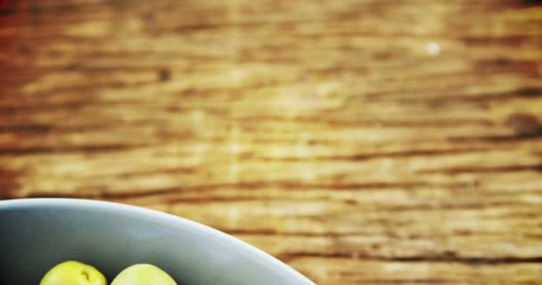 Fresh green olives and rosemary in a bowl — Stock Video