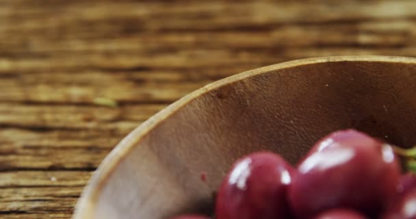 Fresh red olives and rosemary in a bowl — Stock Video