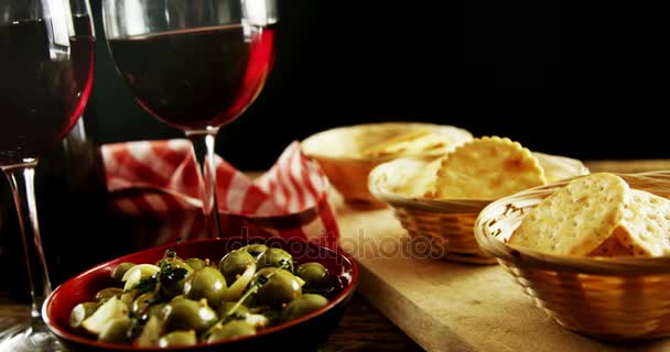 Red wine served with olive tapas — Stock Video