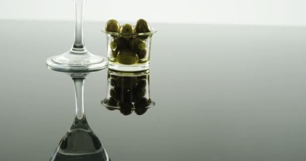 Cocktail glass decorated with olive stick — Stock Video