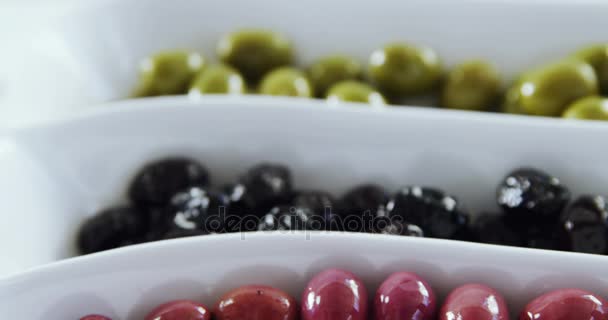 Green, black and red pickled olives — Stock Video