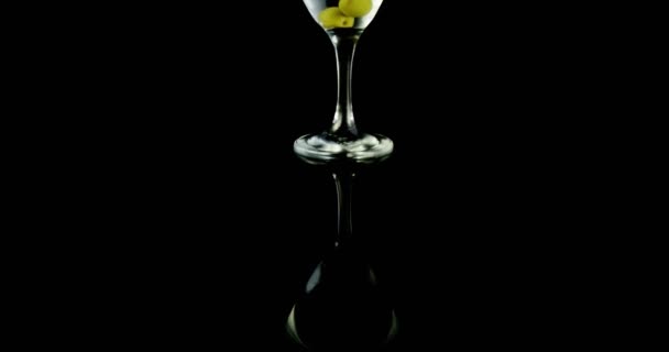 Glass of cocktail with green olives — Stock Video