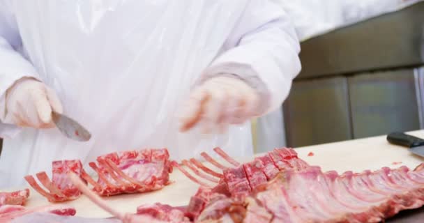 Female butcher cutting raw meat — Stock Video