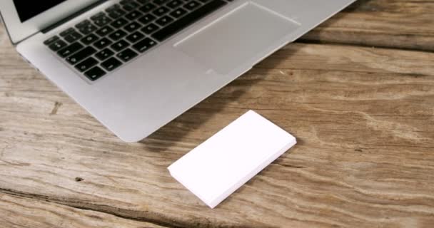 Laptop and stack of business cards — Stock Video