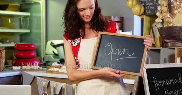 Portrait of a female staff holding a open sign — Stock Video