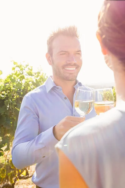 Smiling man with woman toasting wine — Stock Photo, Image