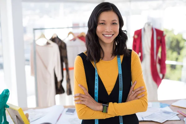 Fashion designer standing with arms crossed — Stock Photo, Image