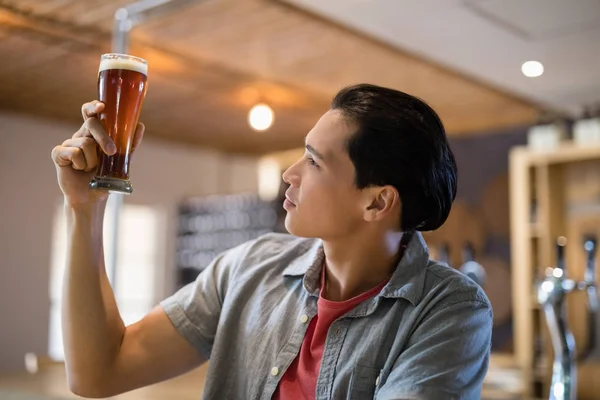 Homem olhando para o copo de cerveja — Fotografia de Stock