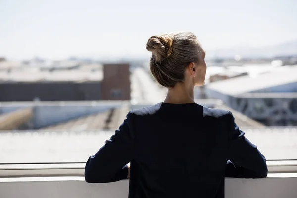 Nachdenkliche Geschäftsfrau blickt durchs Fenster — Stockfoto