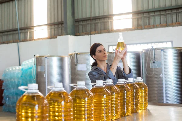 Técnico femenino examinando aceite de oliva — Foto de Stock