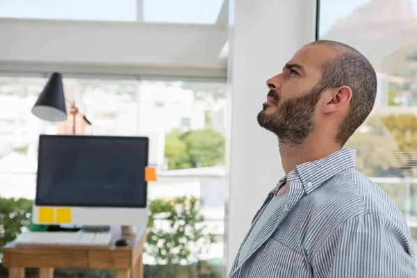 Thoughtful designer looking up — Stock Photo, Image