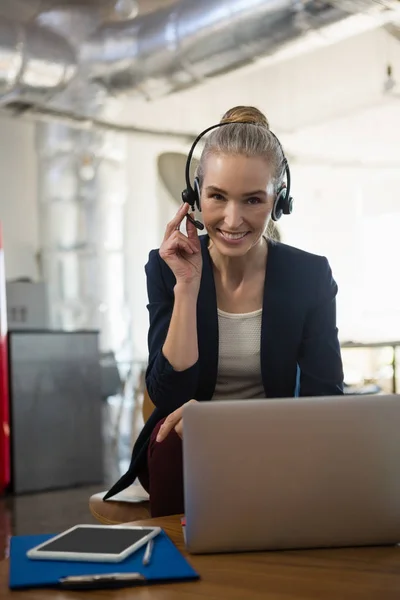 Businesswoman talking through headset — Stock Photo, Image