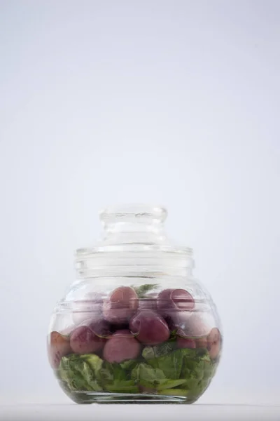 Red olives in jar on table — Stock Photo, Image