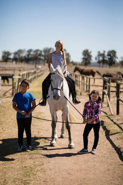 Kids riding a horse in the ranch — Stock Photo, Image