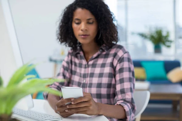 Female executive using mobile phone — Stock Photo, Image