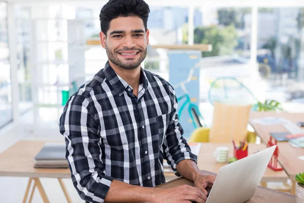 Male executive working on laptop at desk — Stock Photo, Image