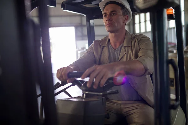 Worker driving forklift — Stock Photo, Image