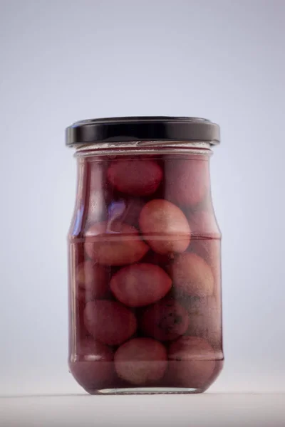 Red olives in glass jar — Stock Photo, Image