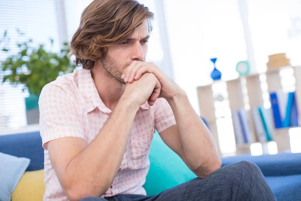 Depressed male executive sitting on sofa — Stock Photo, Image