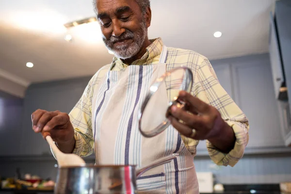 Senior man bereiden van voedsel thuis — Stockfoto