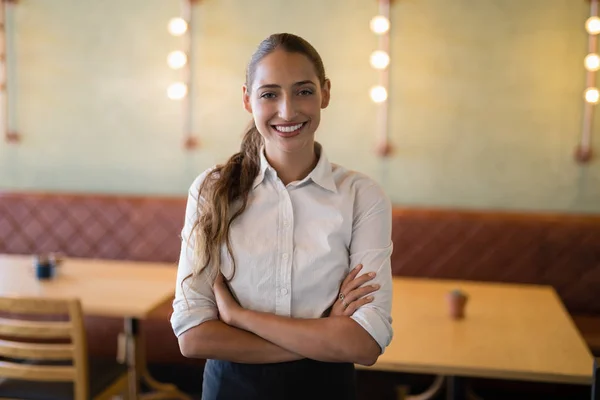 Female bartender standing with arms crossed — Stock Photo, Image