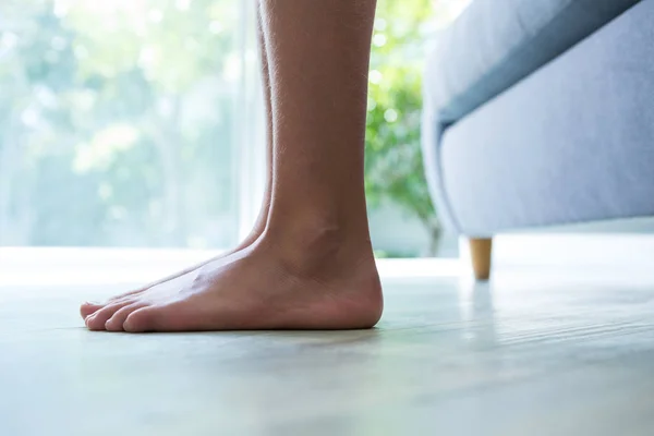 Girl standing next to sofa — Stock Photo, Image