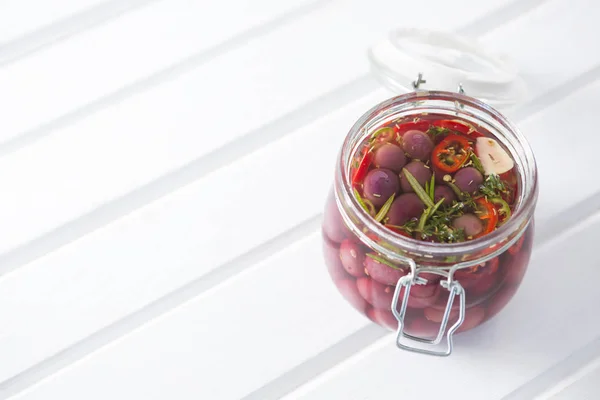 Pickled olives and vegetables in jar — Stock Photo, Image