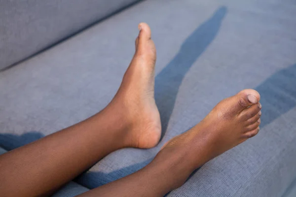 Boy lying on sofa at home — Stock Photo, Image