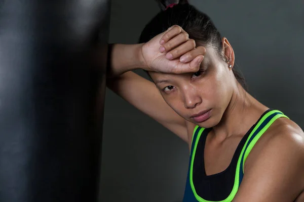 Man leaning on punching bag — Stock Photo, Image