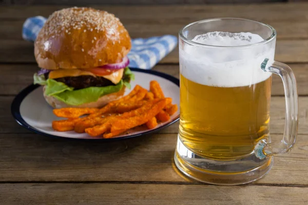 Burger and french fries with glass of beer — Stock Photo, Image