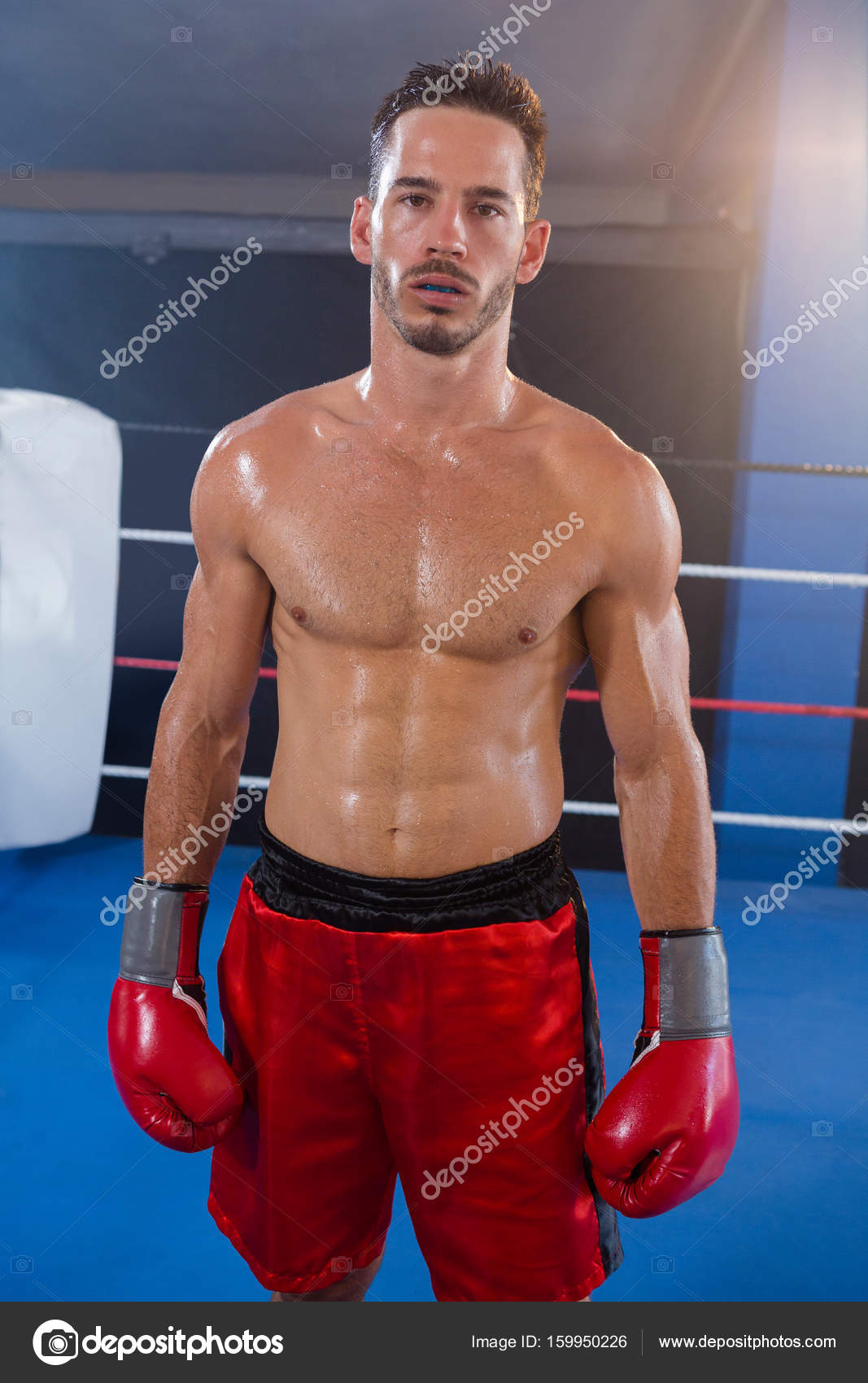 Male boxer wearing red gloves Stock Photo by ©Wavebreakmedia 159950226