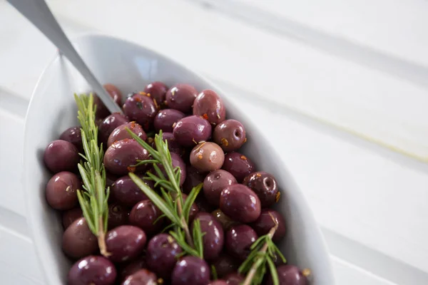 Olives garnished with rosemary — Stock Photo, Image