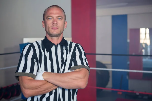 referee standing with arms crossed