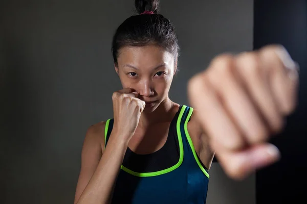 woman practicing boxing in fitness studio