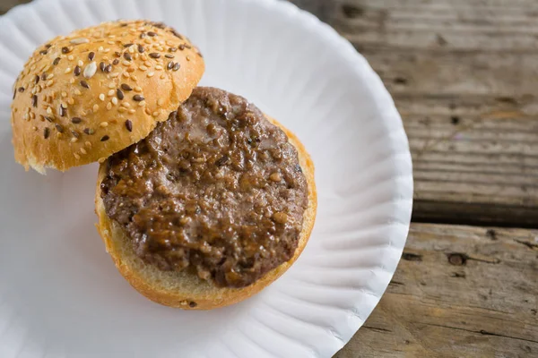 Opened hamburger in plate — Stock Photo, Image