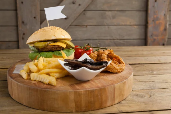 Hamburger with onion rings and french fries — Stock Photo, Image