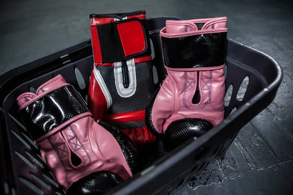 Boxing gloves in basket — Stock Photo, Image