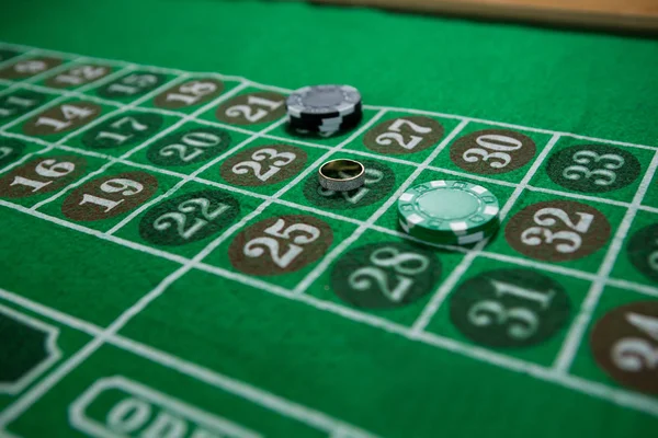 Ring and chips on roulette table — Stock Photo, Image