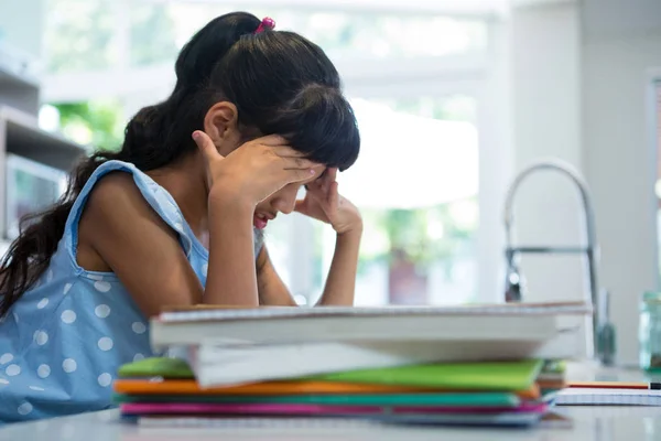 Exhausted girl sitting with books — Stock Photo, Image