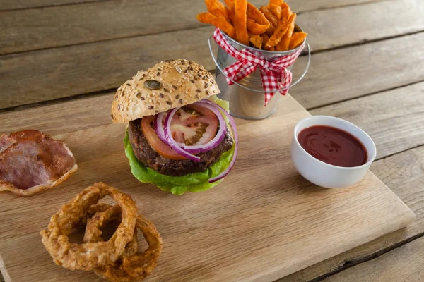 Hamburger with french fries and onion rings — Stock Photo, Image