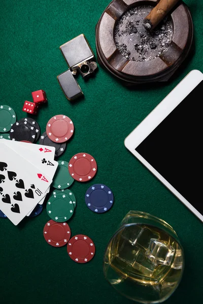 Ashtray with digital tablet and casino chips — Stock Photo, Image