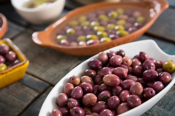 Маринованные оливки в белой чаше — стоковое фото