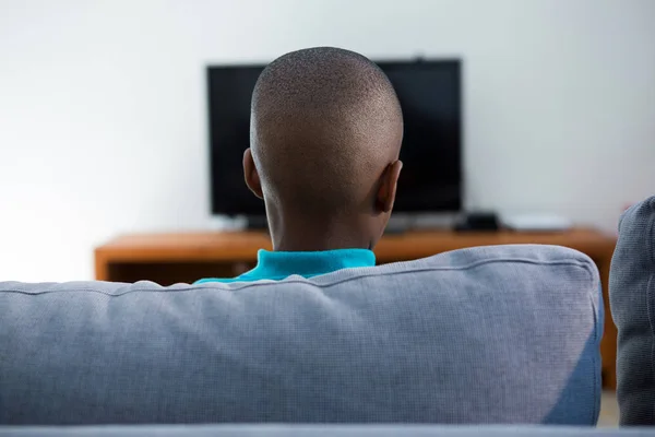 Boy sitting on sofa at home — Stock Photo, Image