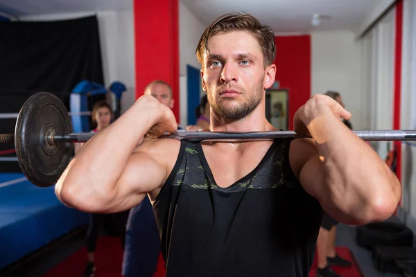 Male athlete lifting barbell — Stock Photo, Image