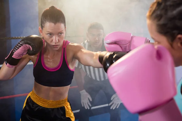 Female athletes fighting in boxing ring — Stock Photo, Image