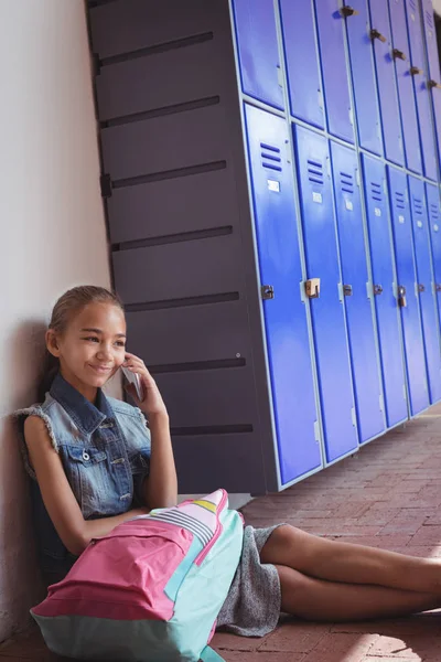 Elementary schoolgirl talking on phone — Stock Photo, Image