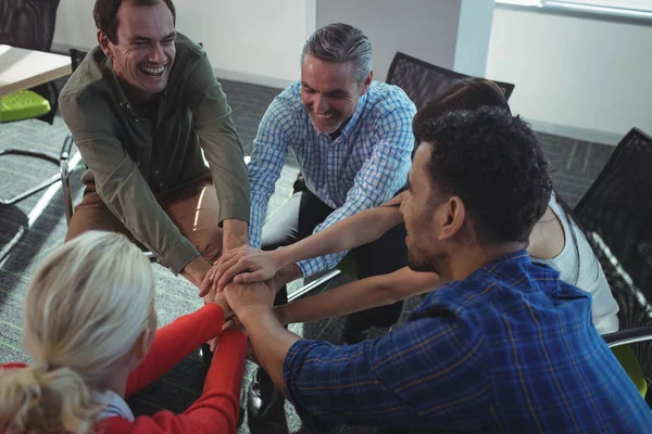 Business colleagues stacking hands at office — Stock Photo, Image